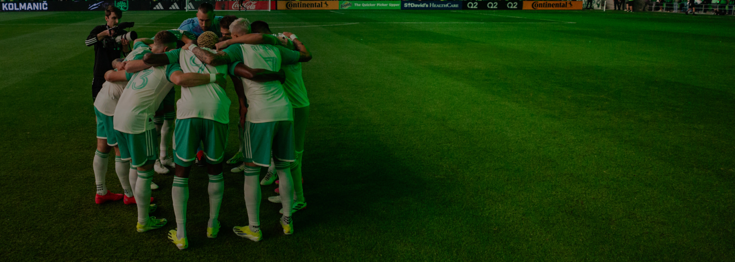 Austin FC players huddled on the field