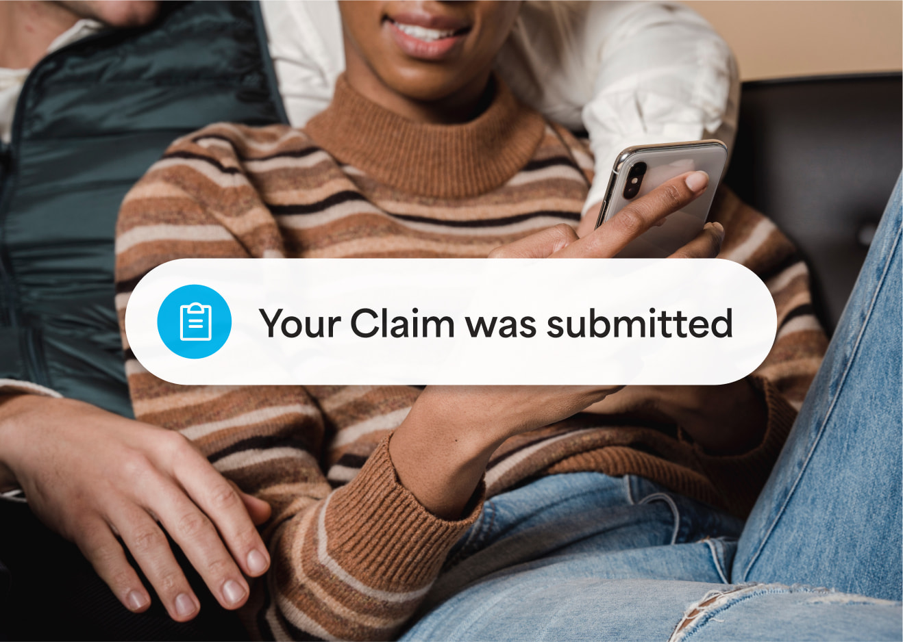 Couple on their phone with a claim submitted notification