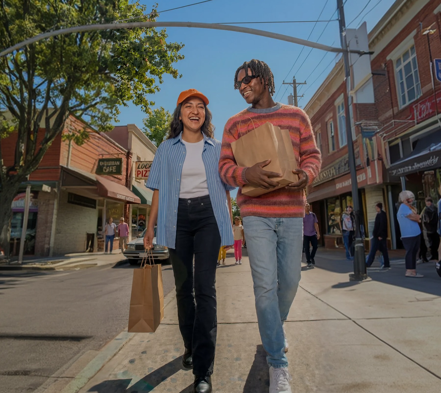 Young adults walking down the street with groceries